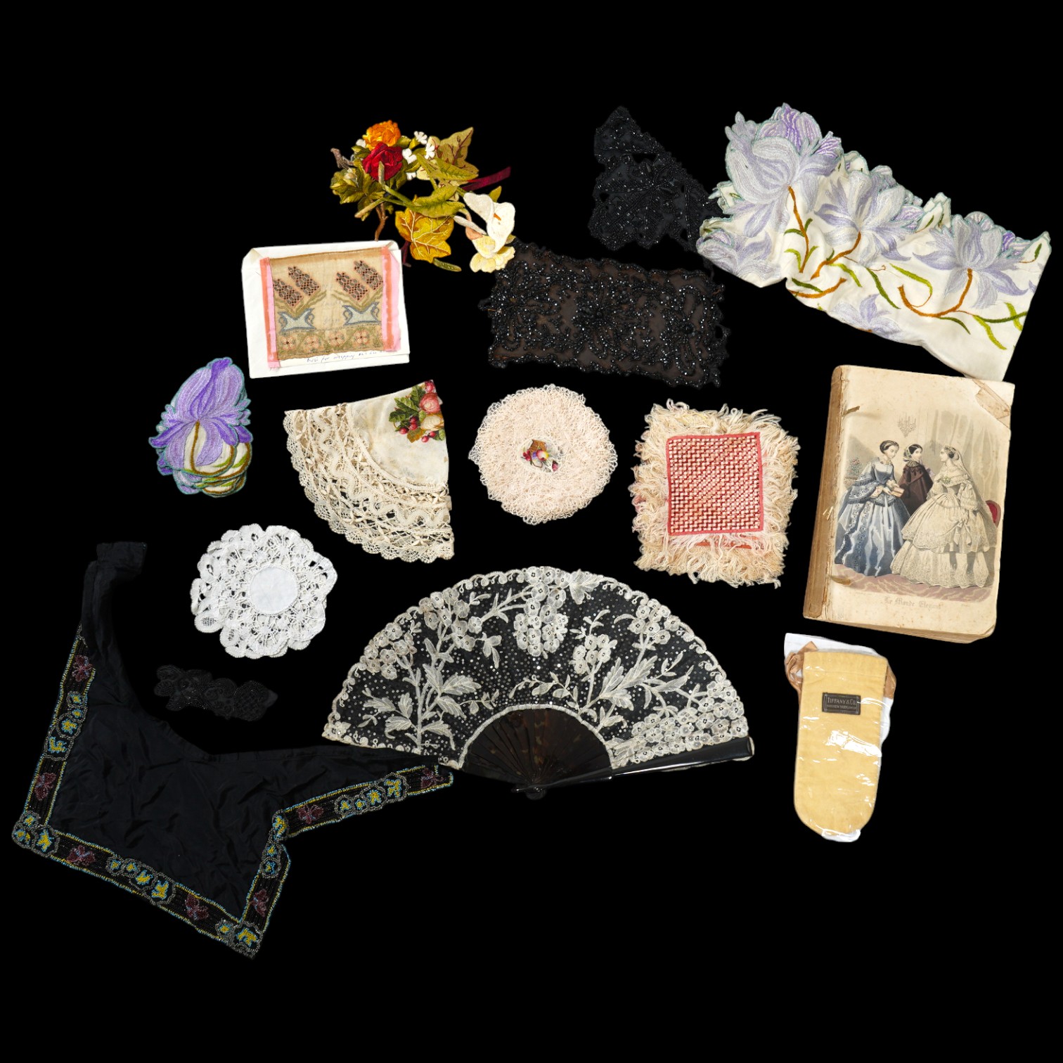 A French tortoiseshell, net, sequin and Honiton bobbin lace fan, with a collection of Jet appliques, a bead work fronter, embroidered mats and silk mats, an early Tiffany &Co poshette and embroidered appliqués and a Le M